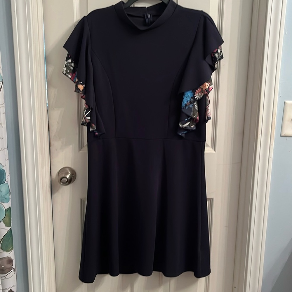 Navy stretch dress with beautiful colorful ruffled sleeves and zip/button back